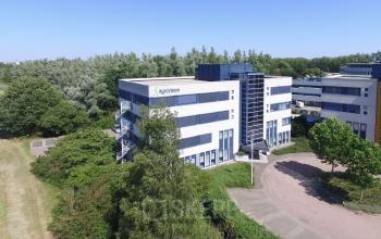 Exterior view of a modern office building at Keulenstraat 15, Deventer, perfect for office space rental, surrounded by greenery.