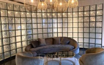 Modern office to rent at Keulenstraat 1, Deventer, featuring stylish seating with plush furniture and chic lighting, ideal for a welcoming reception area. Perfect for office space rental needs.