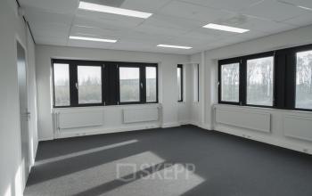 Spacious office space for rent at Keulenstraat 1, Deventer, with large windows providing ample natural light.