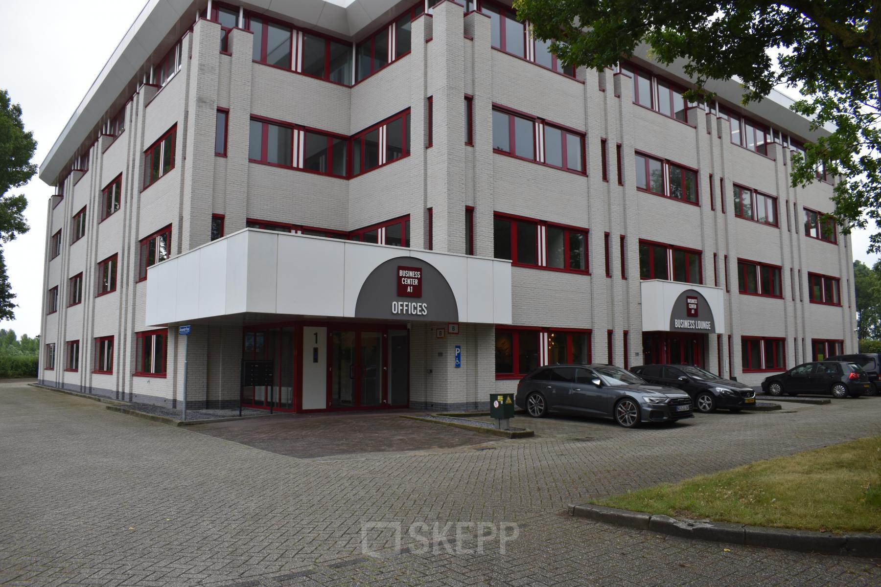 Exterior view of rentable office space at Keulenstraat 1, Deventer. The building features parking spaces and multiple office rental opportunities.