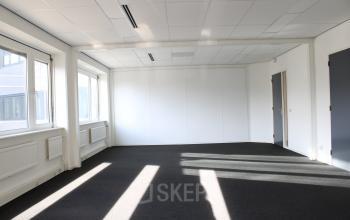 Unfurnished office space with large windows allowing natural light at Keulenstraat 12, Deventer, ideal for office space rental.
