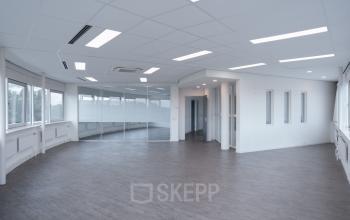 Spacious office space with large windows and modern lighting located at Keulenstraat 12, Deventer, suitable for office space rental.