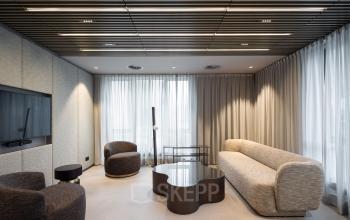 Modern office space rental at Diemerhof 42 in Diemen featuring a stylish lounge area with comfortable seating and ambient lighting.