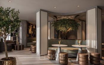 Stylish office lounge at Diemerhof 42, Diemen, offering a modern setting with plush seating and greenery, ideal for office space rental.