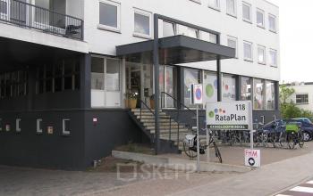 Exterior view of office building at Weesperstraat 118, Diemen, with a prominent staircase entrance and bicycle parking nearby.