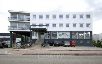 Exterior of Weesperstraat 118 office building in Diemen, featuring multiple windows, a stair entrance, parking, and visible office space for rent.