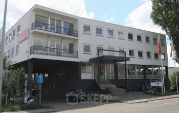 Exterior view of office building at Weesperstraat 118, Diemen with parking area and bicycles.