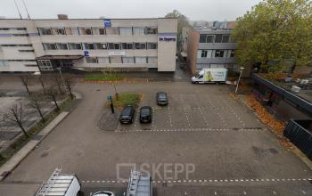 Exterior view of the office building located at Berglaan 4-8, in Drachten, showcasing the building facade and parking area suitable for office space rental.