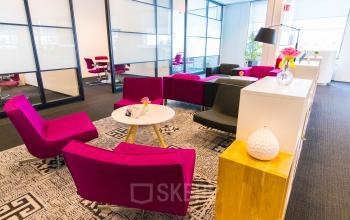 Bright office lounge at Eindhoven Airport's Flight Forum 40, featuring vibrant seating and modern decor. Ideal for office space rental.