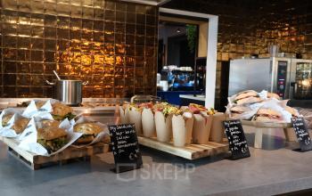 Inviting pantry area at Flight Forum 760-780, Eindhoven Airport, featuring a variety of gourmet sandwiches and snacks, perfect for break time. Ideal for casual office space rental settings.