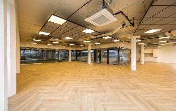 Bright office space at Luchthavenweg 81, Eindhoven Airport, featuring large windows and modern flooring, ideal for businesses seeking office space rental.