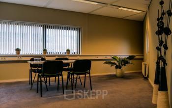 Office to rent at Luchthavenweg 55, Eindhoven Airport, featuring a small table with four chairs, potted plants, and ample natural light from the windows.