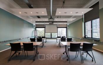 Spacious, modern office to rent at Lichttoren 32, Eindhoven Center, featuring multiple workstations and large windows enhancing natural light. Ideal for office space rental.