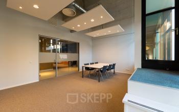 Spacious office at Lichttoren 32 in Eindhoven Center, featuring a meeting table and chairs. Ideal for office space rental.