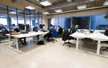 Spacious office space rental at Bogert 1, Eindhoven Center, with professionals engaged in business activities.