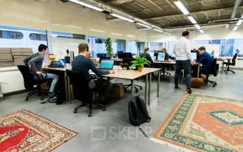 Business professionals actively engaged in work at a well-equipped office space rental at Bogert 1, Eindhoven Center.