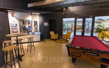 Modern and inviting office space rental at Bogert 1, Eindhoven Center, with a coffee area, pool table, and casual seating arrangement.