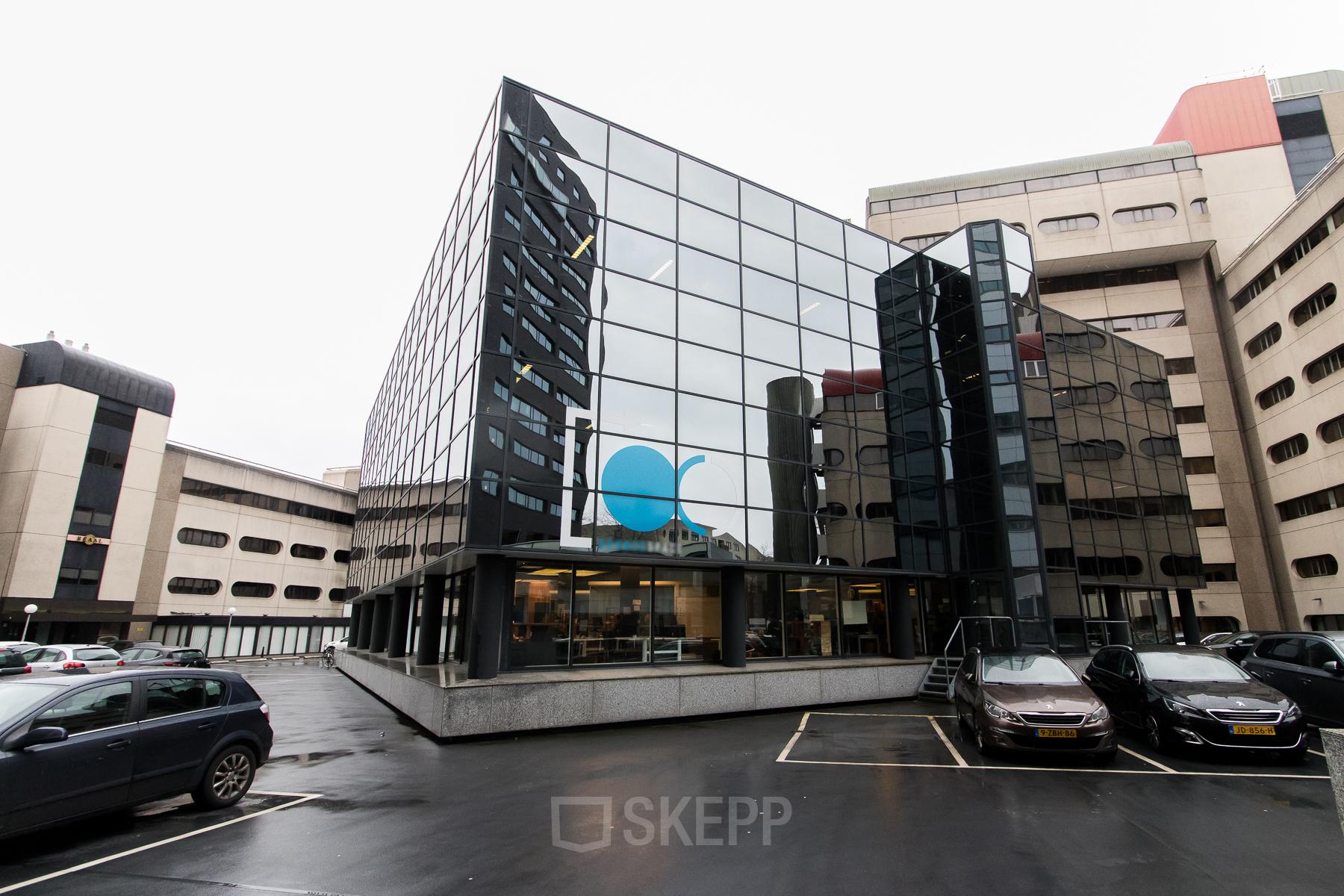 Modern Eindhoven Center office space rental at Bogert 1 with reflective glass facade and parking availability.