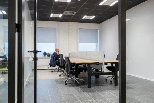 Modern office with individual workspaces at Stadhuisplein 10, Eindhoven Center, featuring sleek furniture and ample natural light, ideal for office space rental.