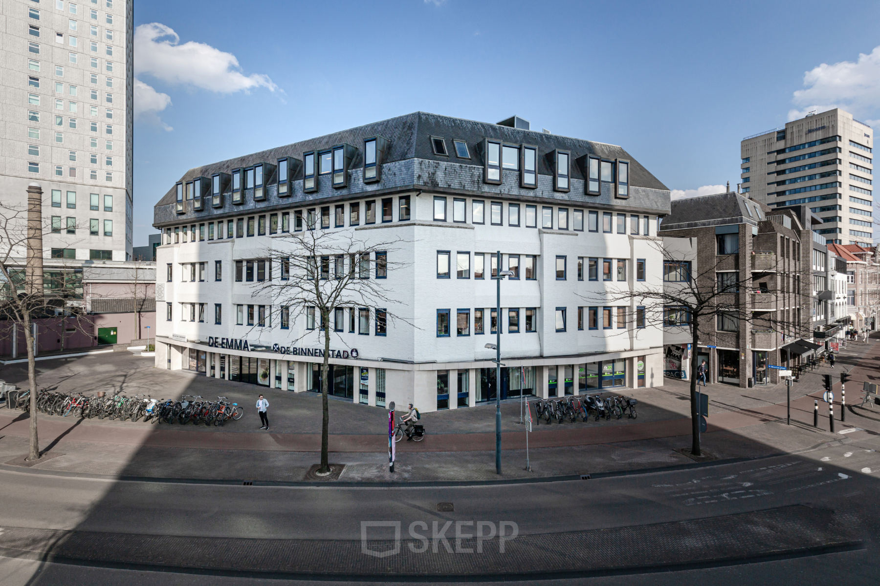 Exterior view of the office building at Emmasingel 33 in Eindhoven Center, suitable for office space rental, with its distinct geometric roof and large windows.