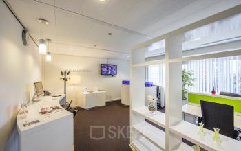 Modern office space at Fellenoord 130, Eindhoven Center with lounge area and desks for rent, featuring bright lighting and simple decor.