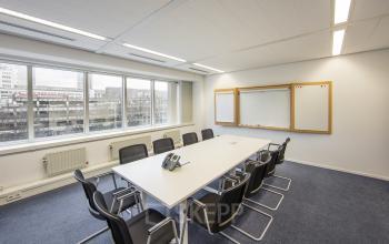 Modern conference room with a large table and chairs for office space rental at Fellenoord 130, Eindhoven Center.