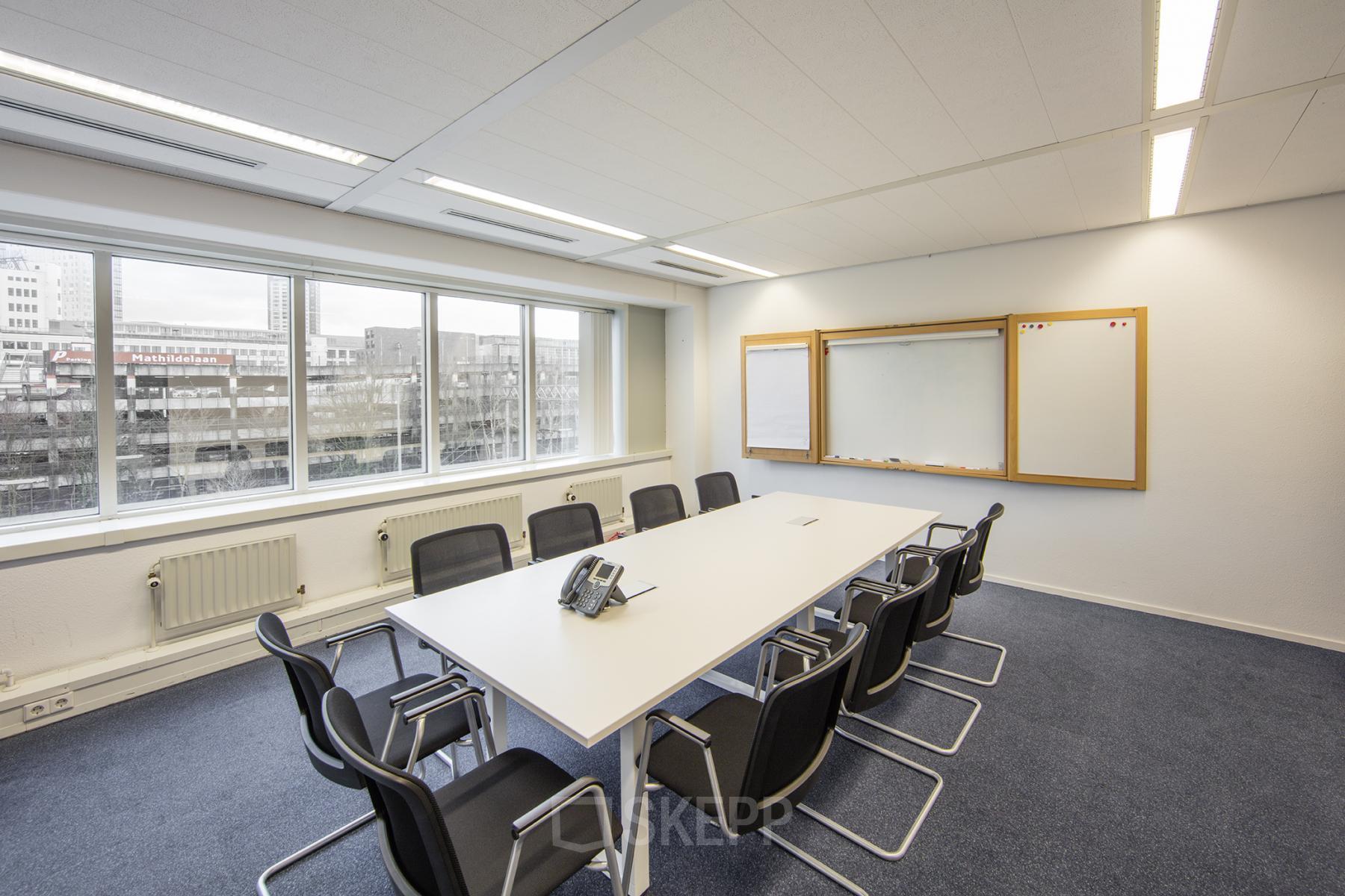 Modern conference room with a large table and chairs for office space rental at Fellenoord 130, Eindhoven Center.