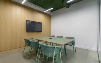 Modern meeting room at Paradijslaan 30-38, Eindhoven Center, featuring a table and chairs, ideal for office space rental.
