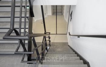 View of a modern staircase with black railings in an office to rent at Paradijslaan 30-38, Eindhoven Center.