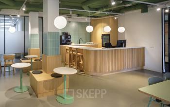 Modern furnished office space at Paradijslaan 30-38, Eindhoven Center, featuring a sleek kitchen area and seating, ideal for office space rental.