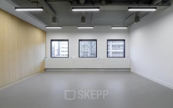 Spacious office to rent in Eindhoven Center with large windows and modern lighting, ideal for office space rental.