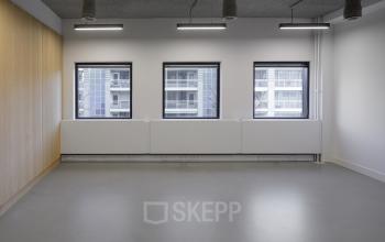 Spacious and bright office space for rent in Eindhoven Center with large windows and modern lighting.