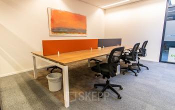 Office space rental at Paradijslaan 30-38, Eindhoven Center, featuring a modern workspace with desks, chairs, and colorful wall art.