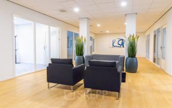 Modern open floorplan office space rental at Paradijslaan 30-38, Eindhoven Center, featuring comfortable seating and natural lighting.