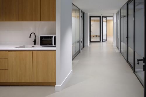 Interior view of office space rental at Paradijslaan 30-38, Eindhoven Center, featuring a hallway with private offices and a kitchenette area.
