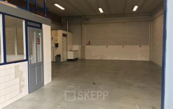 Interior of an office space at Kanaaldijk-Zuid 19, Eindhoven Center, Eindhoven, with concrete floors and simple lighting, ideal for office space rental.