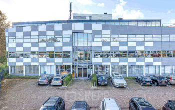 Exterior view of a modern office building at Meerenakkerplein 1-10, Eindhoven De Hurk, with parking spaces available for office space rental.
