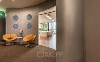 Modern office interior at Meerenakkerplein 11-20, Eindhoven De Hurk with stylish seating and visible meeting room, ideal for rent office space.