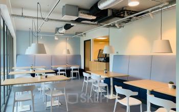 Modern office lounge area at Hurksestraat 60, Eindhoven De Hurk, with contemporary furniture and overhead lighting.