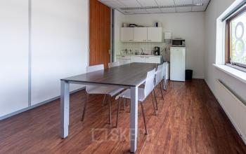 Office pantry at Le Havre 114-127, Eindhoven North, with a small kitchenette, table, and chairs, offering comfortable office space rental.