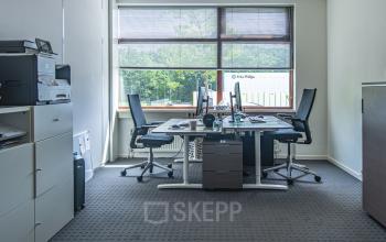 Modern office space with two desks, office chairs, storage units, and a printer, located at Le Havre 114-127, Eindhoven North, available for office space rental.