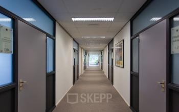 Corridor view inside office space for rent at Weegschaalstraat 3, Eindhoven North, showcasing entryways to several offices.