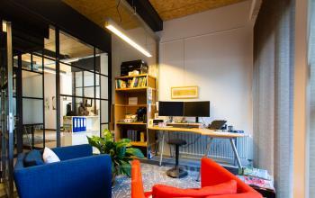 Bright office space at Weegschaalstraat 3, featuring modern furnishings with colorful chairs and a work desk, ideal for office space rental in Eindhoven North.