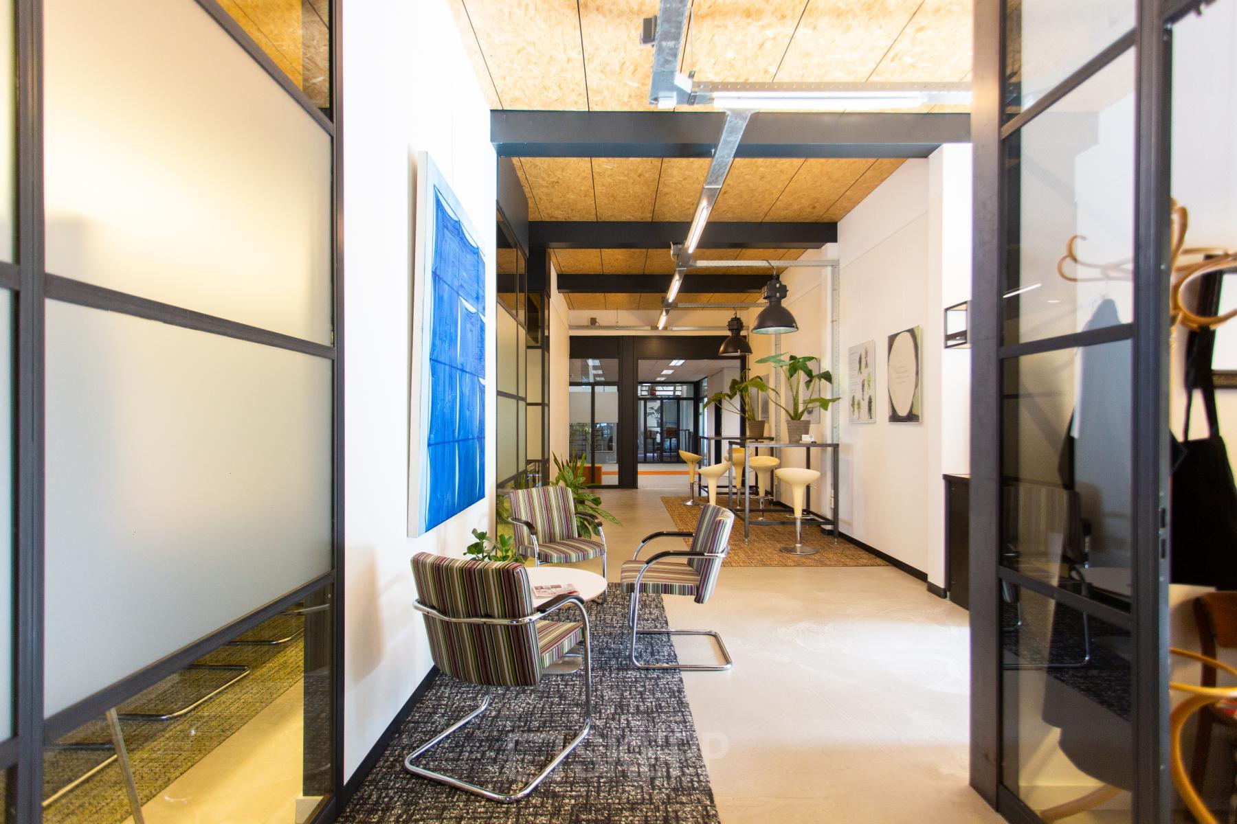 Bright and inviting workspace in Eindhoven North at Weegschaalstraat 3, perfect for office space rental with modern furnishings and cozy seating areas.