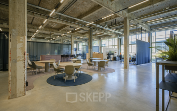 Stylish and spacious office to rent at Frederiklaan 10A in Eindhoven Strijp-S, featuring modern open floor plan with natural light, seating areas, and industrial design elements for collaborative workspaces.
