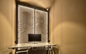 Interior view of a furnished office space rental at Achtseweg Zuid 159R, Eindhoven Strijp-S, featuring a modern desk setup with subtle lighting.