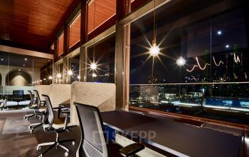 Modern office space for rent in Eindhoven Strijp-S with well-lit desks and city views, ideal for office space rental.