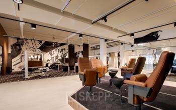 Furnished office to rent in Eindhoven Strijp-S at Frederiklaan 10E, featuring modern workspaces with unique seating and artistic decor.