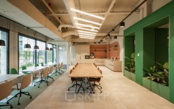 Modern office space at Frederiklaan 10E, Eindhoven Strijp-S with a long conference table, chairs, and well-lit interior for office space rental.