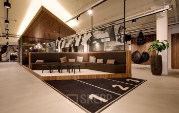 Modern office to rent at Frederiklaan 10E, Eindhoven Strijp-S, featuring a stylish seating area with contemporary furnishings and artistic decor. Ideal for office space rental in a vibrant setting.